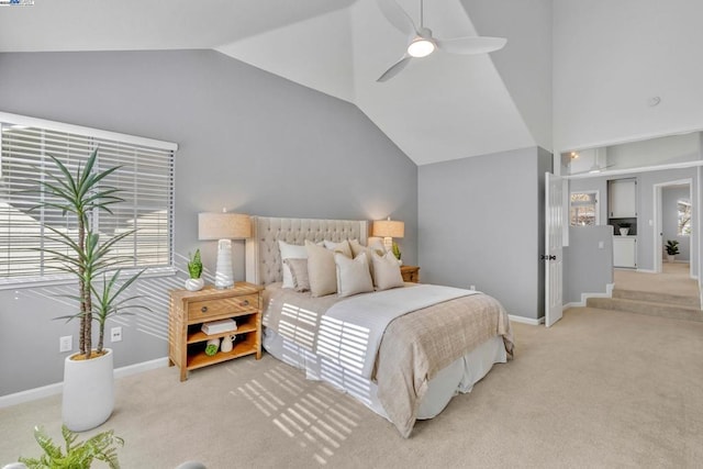 carpeted bedroom with ceiling fan and vaulted ceiling