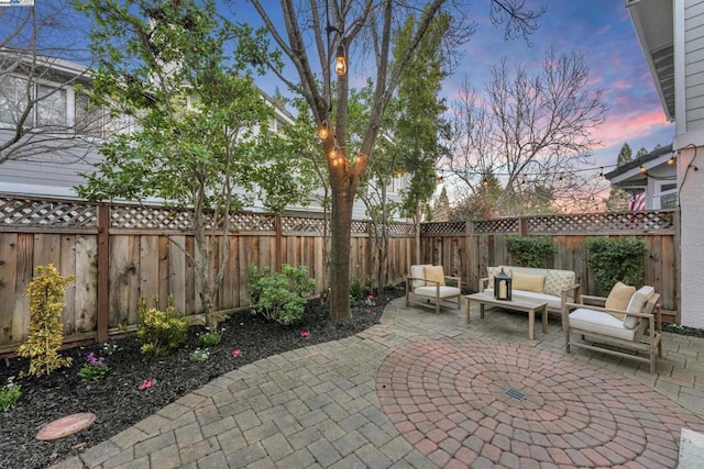 patio terrace at dusk featuring outdoor lounge area