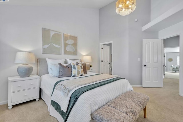 bedroom featuring a towering ceiling and light colored carpet