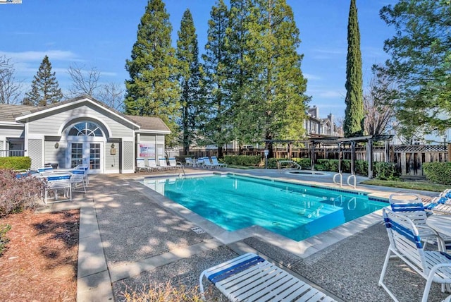 view of pool featuring a patio and an outbuilding