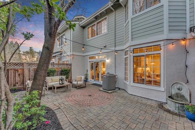 patio terrace at dusk with an outdoor hangout area and central AC