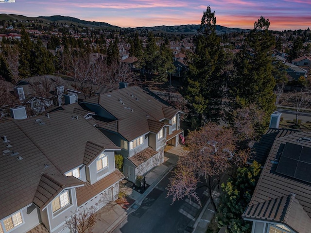 aerial view at dusk featuring a mountain view