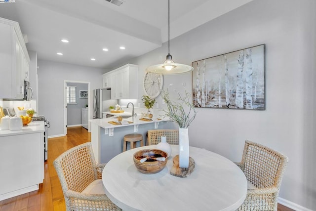 dining area featuring washer / dryer and light wood-type flooring