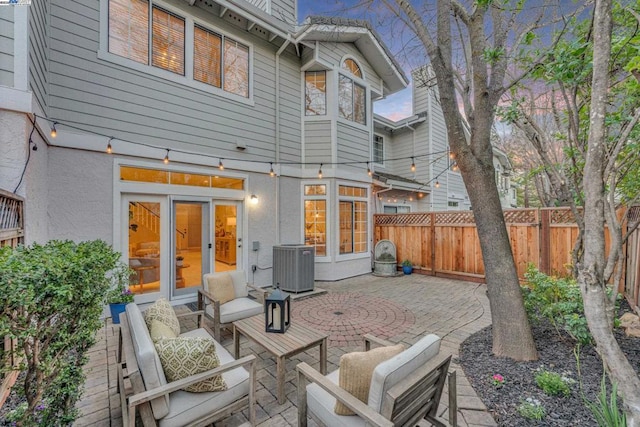 rear view of property featuring a patio area, an outdoor hangout area, and central air condition unit