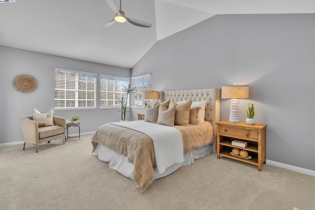 carpeted bedroom with ceiling fan and vaulted ceiling