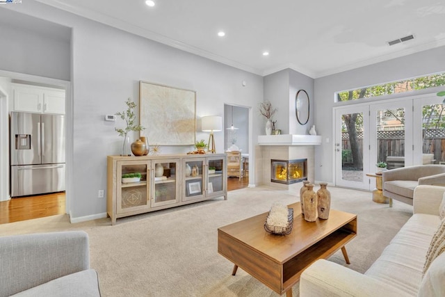 carpeted living room featuring ornamental molding