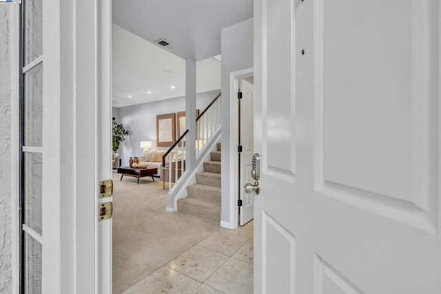 view of carpeted foyer entrance