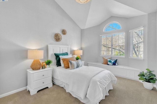 bedroom with lofted ceiling and light carpet