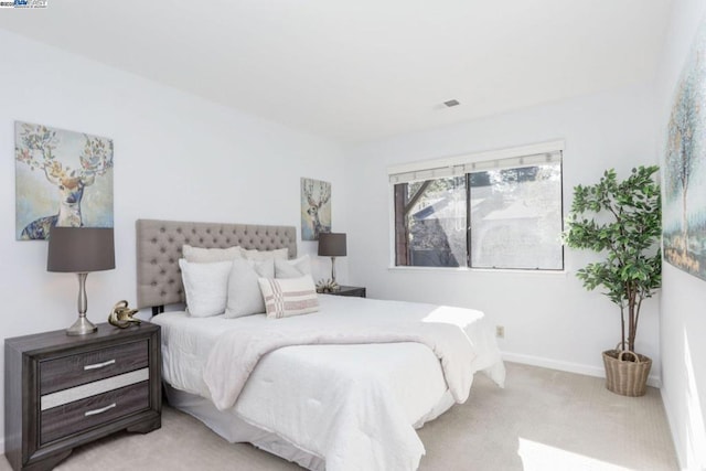 bedroom featuring light colored carpet