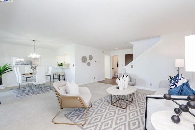 living room with light colored carpet and a notable chandelier