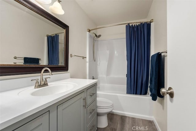 full bathroom with shower / tub combo, wood-type flooring, vanity, and toilet