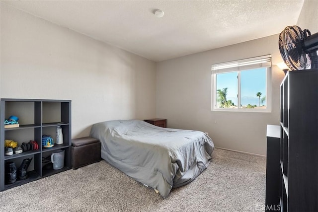 bedroom with a textured ceiling and light carpet