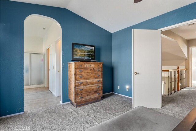 carpeted bedroom featuring lofted ceiling and ceiling fan