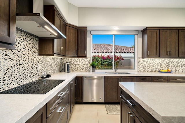 kitchen with black electric stovetop, wall chimney exhaust hood, decorative backsplash, and sink