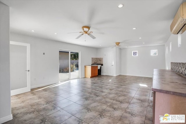 unfurnished living room featuring ceiling fan and a wall mounted AC