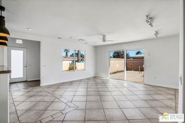 unfurnished room with ceiling fan and light tile patterned floors