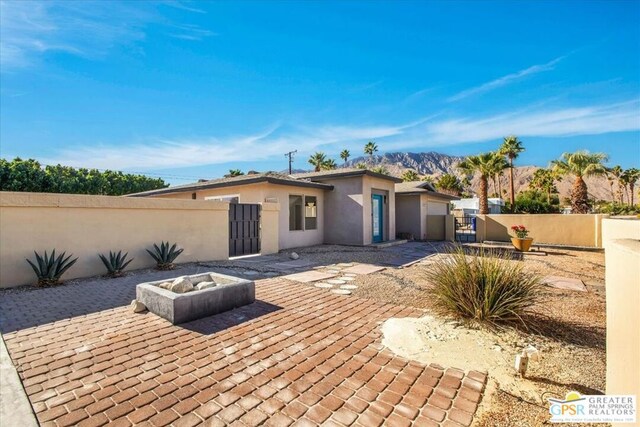 view of front facade featuring a patio and a mountain view