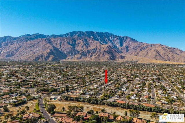 birds eye view of property with a mountain view