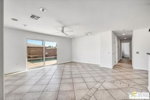 empty room with rail lighting and ceiling fan