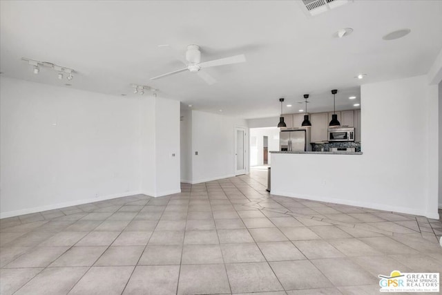 unfurnished living room featuring ceiling fan and light tile patterned flooring