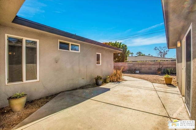 view of side of home with a patio