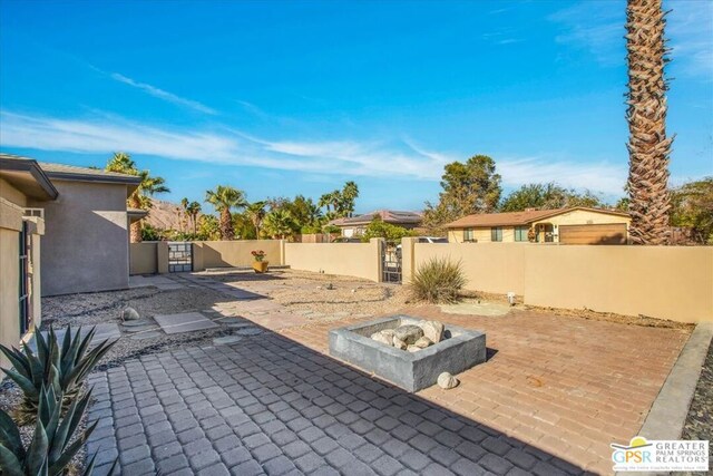 view of patio / terrace with an outdoor fire pit