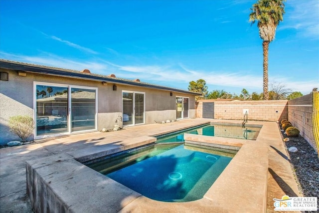 view of swimming pool featuring an in ground hot tub