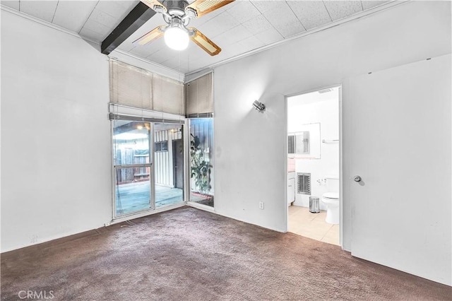 spare room with carpet floors, ceiling fan, beamed ceiling, and crown molding