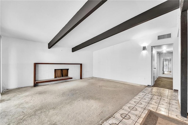 unfurnished living room with a brick fireplace, light colored carpet, and lofted ceiling with beams