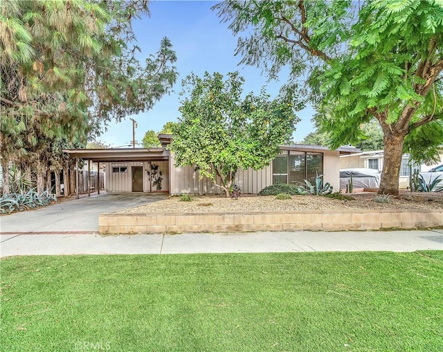 view of front facade with a front yard and a carport