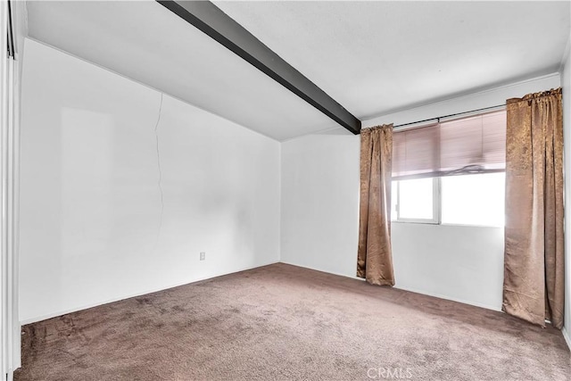 unfurnished room featuring carpet flooring and vaulted ceiling with beams