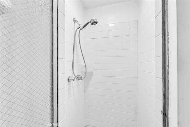 bathroom with a tile shower