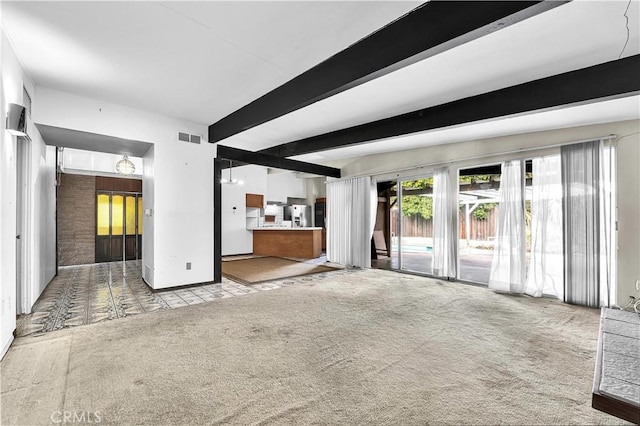 unfurnished living room featuring light carpet and beam ceiling