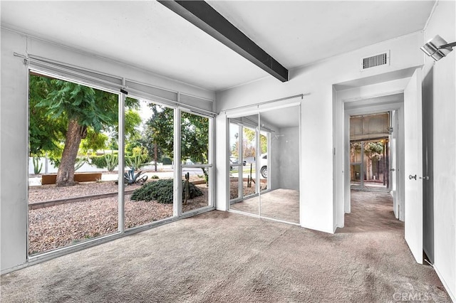 unfurnished sunroom with beam ceiling