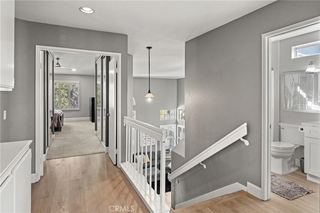 corridor with light hardwood / wood-style floors