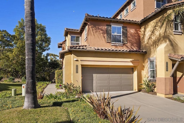 mediterranean / spanish-style house with a garage