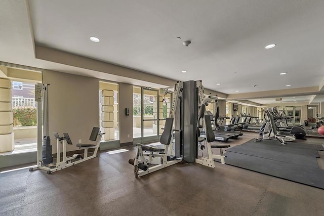 exercise room featuring a tray ceiling