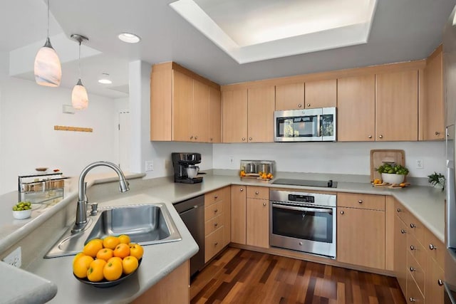 kitchen featuring sink, light brown cabinetry, pendant lighting, and appliances with stainless steel finishes