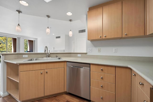 kitchen with sink, light hardwood / wood-style floors, kitchen peninsula, stainless steel dishwasher, and pendant lighting