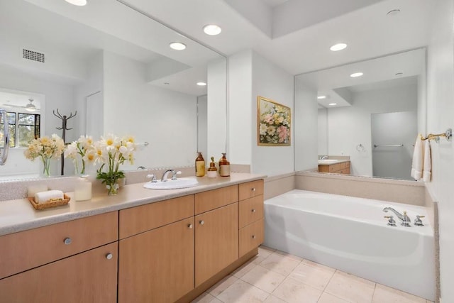 bathroom with vanity, tile patterned flooring, and a bathing tub