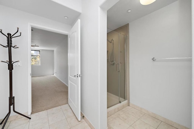 bathroom featuring tile patterned floors and a shower with shower door