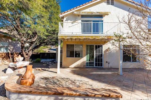 rear view of property with a balcony and a patio