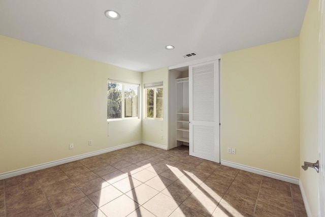 unfurnished bedroom featuring a closet and light tile patterned floors