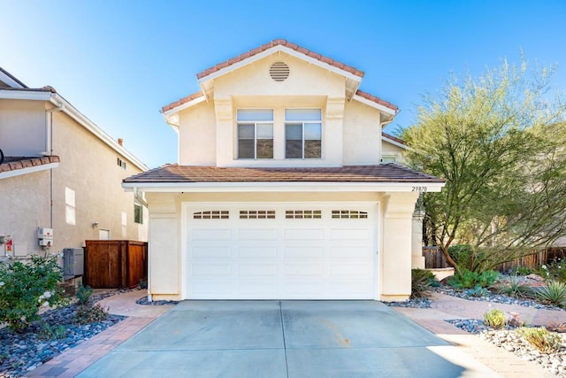 front facade with central AC unit and a garage