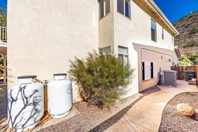 view of side of home featuring a patio and central AC unit