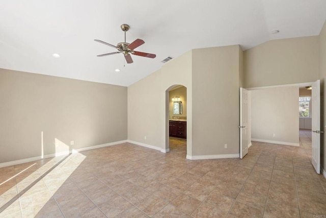 spare room with light tile patterned flooring, ceiling fan, and vaulted ceiling