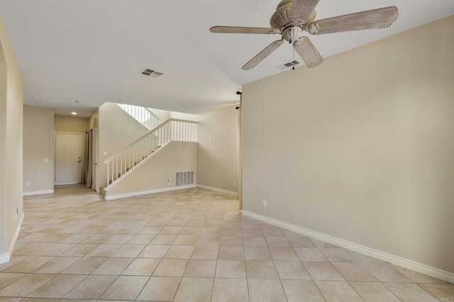 tiled spare room with ceiling fan