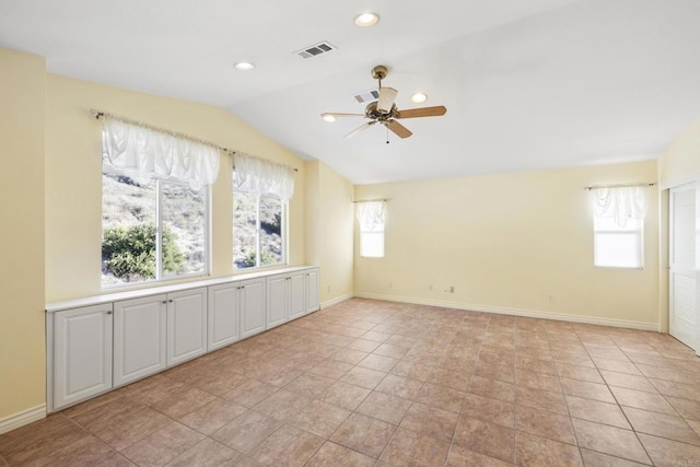 tiled spare room with lofted ceiling and ceiling fan