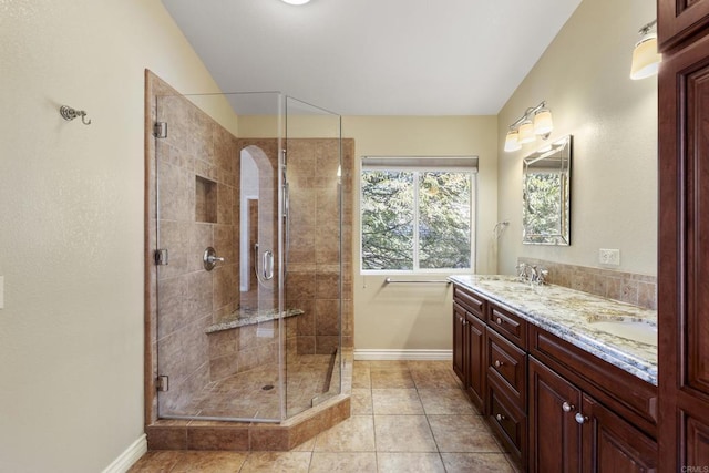 bathroom with vanity, walk in shower, tile patterned flooring, and lofted ceiling