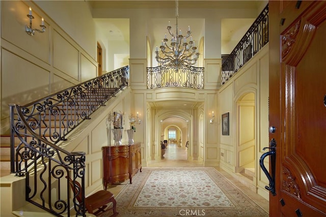 foyer entrance featuring a high ceiling and an inviting chandelier